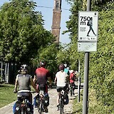 Cycling into Ficarolo with its leaning tower. (photo by James C.)