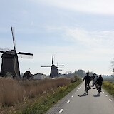 bike tour group passing multiple windmills (photo by Brian W.)