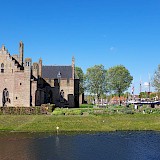 Cycling by Medemblik castle - our boat in the background (photo by Cheryl S.)
