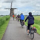 Riding by one of the many windmills in Kinderdijk (photo by Sue B.)