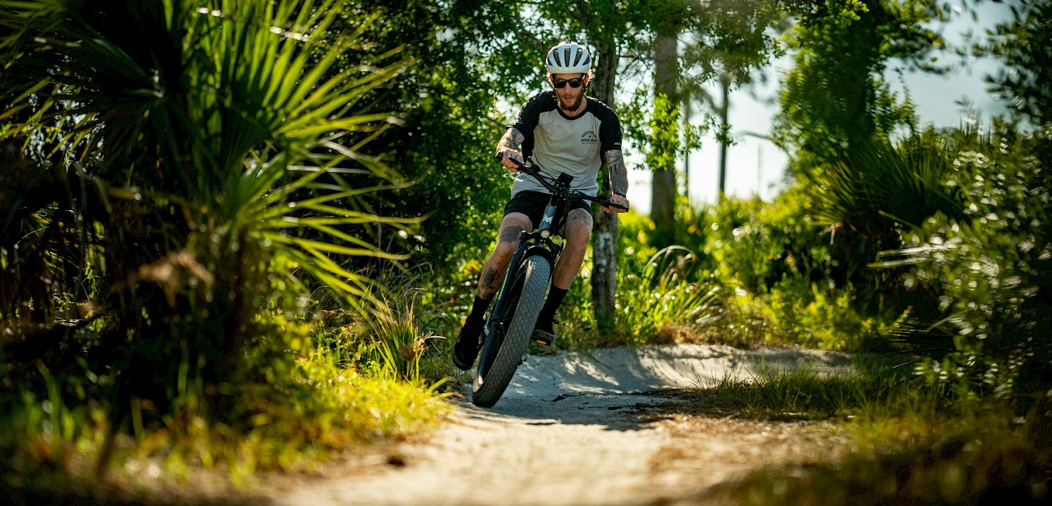 Mountain biking down a path. Unsplash@Mukkpetebike