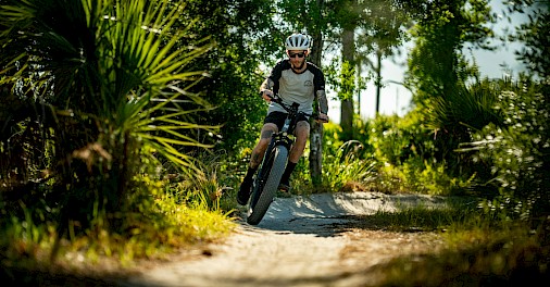 Mountain biking down a path. Unsplash@Mukkpetebike