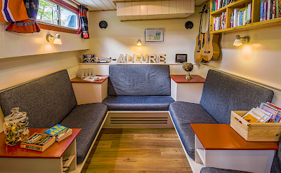 Cozy library and seating area aboard the Allure | Bike & Boat Tours