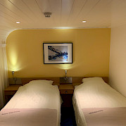 Twin bed setting aboard the Merlijn - Bike & Boat Tours
