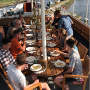 Enjoying a meal on deck | Zwaan | Bike & Boat Tours