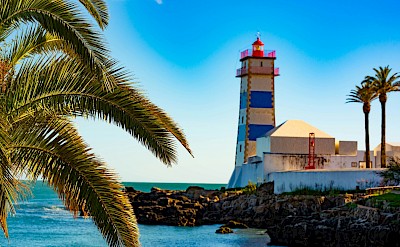 Blue striped lighthouse, Cascais, Portugal. Unsplash@Jeroen den Otter