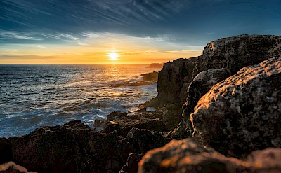 Sunset at the cliffs, Cascais, Portugal. Unsplash@Ryan Stanikk