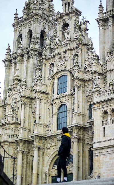 Man looking up at the Praza do Obradoiro, Santiago de Compostela, Spain. Unsplash:Jimmy Fotografia