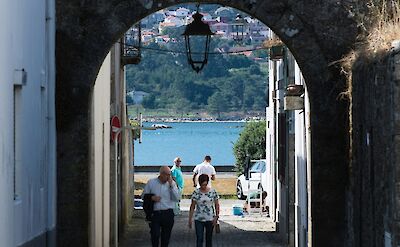 People walking through an archway in Caminha, Portugal. Unsplash:Desert Morocco Adventure