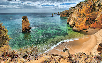 Cliffs and beaches of Algarve, Portugal. Photo via Flickr:Oliver Clarke