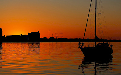 Sunset in the harbor, Stralsund. Image by Kerstin Riemer from Pixabay