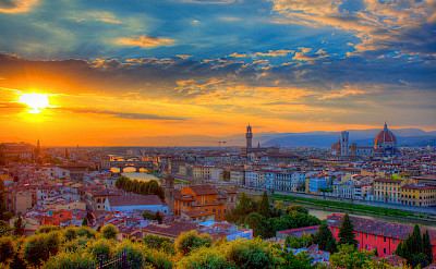 Florence at sunset with the Ponte Vecchio Bridge in Tuscany, Italy. Photo via Flickr:Jiuguang Wang