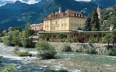 The Adige River flowing through Merano, Italy. Unsplash@Reisetopia