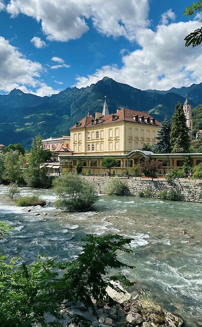 The Adige River flowing through Merano, Italy. Unsplash@Reisetopia