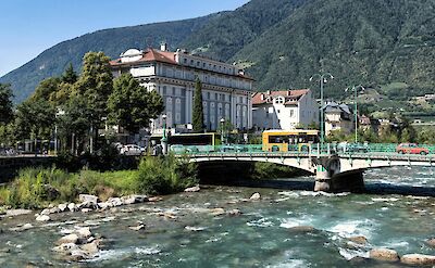 Adige River flowing under a bridge in Merano, Italy. Unsplash@Wolfgang Weiser