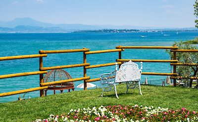 Bench overlooking a lake in Desenzano, Italy. Unsplash@FED