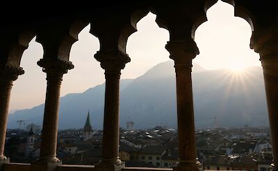 Sunset in Trento, viewed through castle arches, Italy. Unsplash@Joshua Kettle