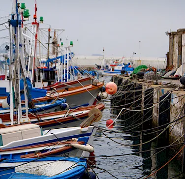 Harbor in Tarifa, Cádiz, Andalusia. This town is known for its wind sports, and located across from the Straits of Gibraltar opposite Morocco. Photo via Flickr:jordiet