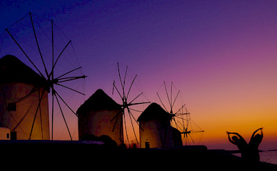 Mykonos Island windmills at sunset, Cyclades Islands, Greece. Photo via Flickr:Hassan Rafeek 
