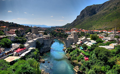 Mostar, a UNESCO Site, on the Neretva River with its most famous bridge in Bosnia-Herzegovina. Photo via Flickr:Kevin Botto