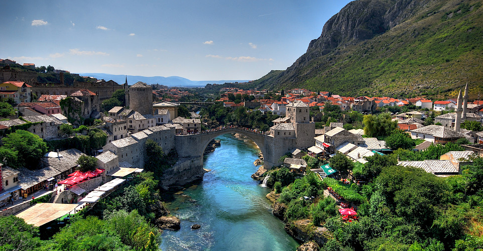 Mostar, a UNESCO Site, on the Neretva River with its most famous bridge in Bosnia-Herzegovina. Photo via Flickr:Kevin Botto