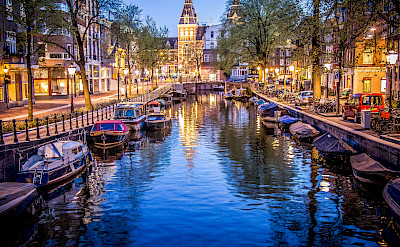 Amsterdam boats in the canal all aglow. Flickr:Sergey Galyonkin