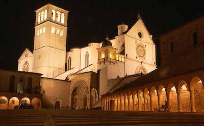The Basilica of Saint Francis of Assisi in Umbria illuminated at night. Unsplash@Adelio