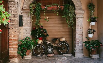 Old motorcycle in the streets of Spello, Italy. Unsplash@Darwin Vegher