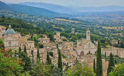 Stone buildings, domes, and bell towers of Assisi. Unsplash@Gary Walker Jones