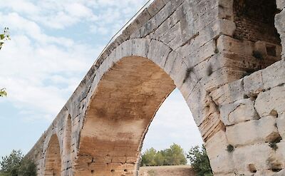 Arched bridge in Bonnieux, France bike tour. Unsplash@Artem R
