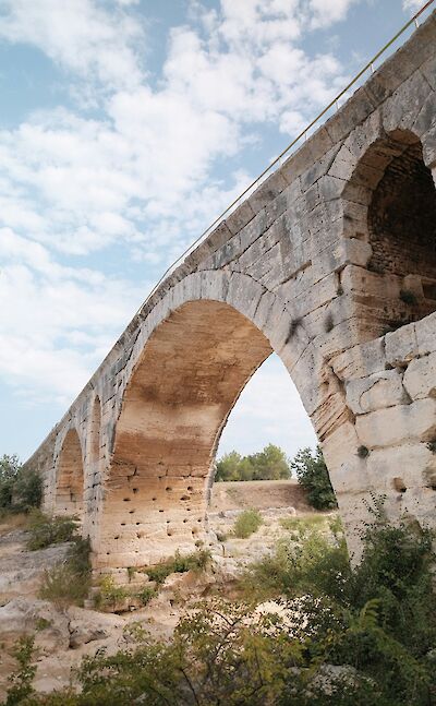 Arched bridge in Bonnieux, France bike tour. Unsplash@Artem R