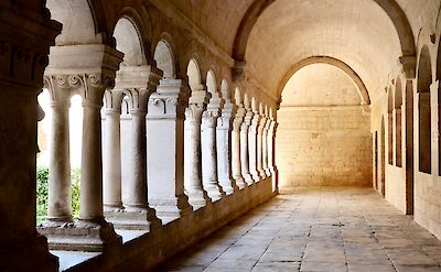 Arched walkway in Gordes, France bike tour. Unsplash@Claudio Poggio