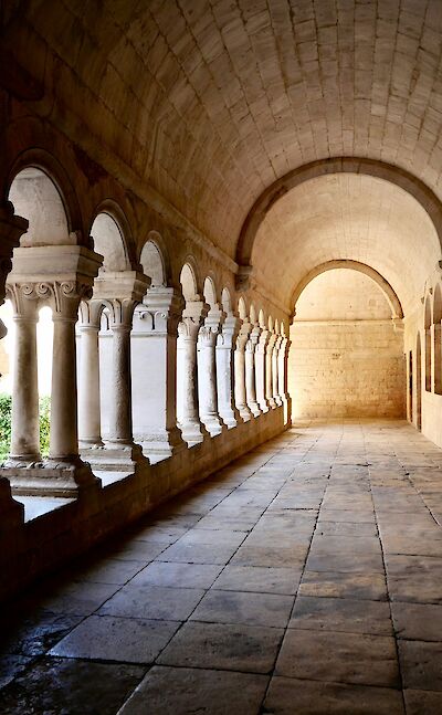 Arched walkway in Gordes, France bike tour. Unsplash@Claudio Poggio