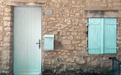 Blue shutters in Gordes, France bike tour. Unsplash@Audric Wonkam