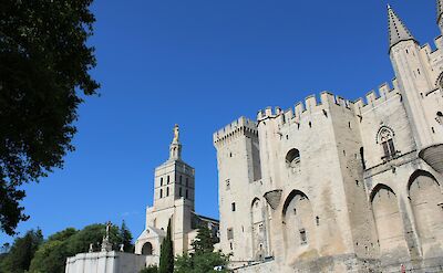 Blue skies above the Palais des Papes, Avignon, France bike tour. Unsplash@Lottie Griffiths