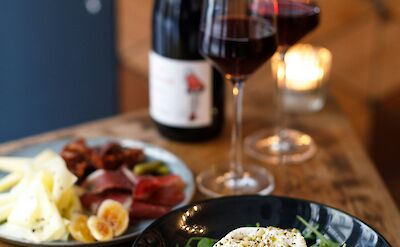 Red wine, cheese, and salad. France bike tour. Unsplash@Alena Torgonskaya