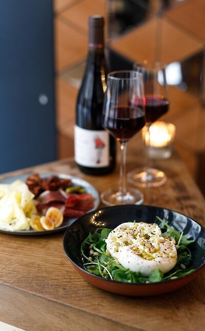 Red wine, cheese, and salad. France bike tour. Unsplash@Alena Torgonskaya