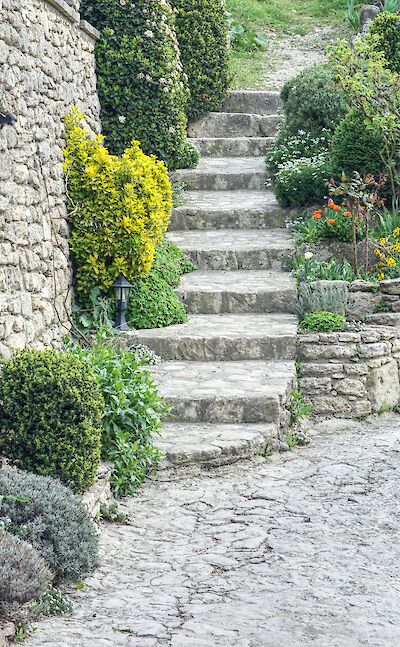 Stone steps in Bonnieux, France bike tour. Unsplash@Frederic Barriol