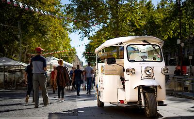 White tuk tuk in Avignon, France bike tour. Unsplash@Tiim