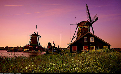 Windmills at sunset, Zaanse Schans. Photo via Flickr:Moyan Brenn