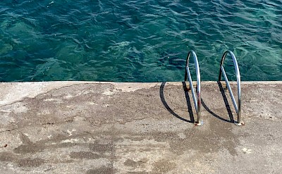 Ladder into the ocean, Salina, Italy. Unsplash@Emma Dickopf