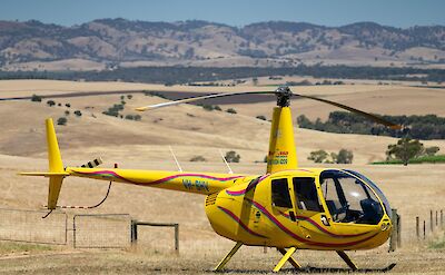 Helicopter in the foreground of the Barossa Valley, Australia. CC:Barossa Helicopters