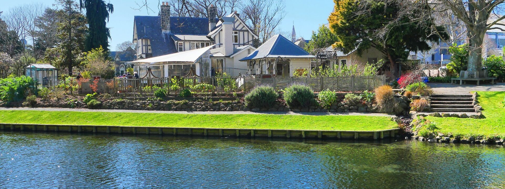 White house with blue roof across the river, Avon River, Christchurch, New Zealand. Brendan Pfahlert@Unsplash