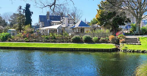 White house with blue roof across the river, Avon River, Christchurch, New Zealand. Brendan Pfahlert@Unsplash