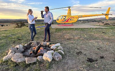 Couple enjoying wine in front of the helicopter, Barossa Valley, Australia. CC:Barossa Helicopters