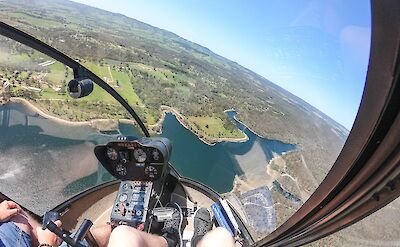 Soaring over a reservoir, Barossa Valley, Australia. CC:Barossa Helicopters