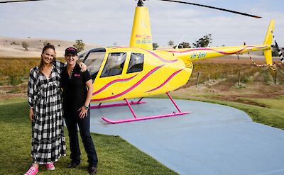 Passenger and pilot outside the helicopter, Barossa Valley, Australia. CC:Barossa Helicopters