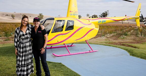 Passenger and pilot outside the helicopter, Barossa Valley, Australia. CC:Barossa Helicopters