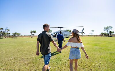 Couple heading to their scenic helicopter flight, Darwin, Australia. CC:Top End Safari Camp