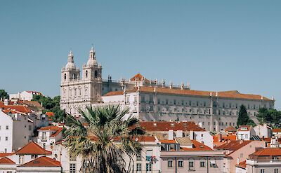 White buildings and red roofs of Alfama, Lisbon, Portugal. Filiz Elaerts@Unsplash